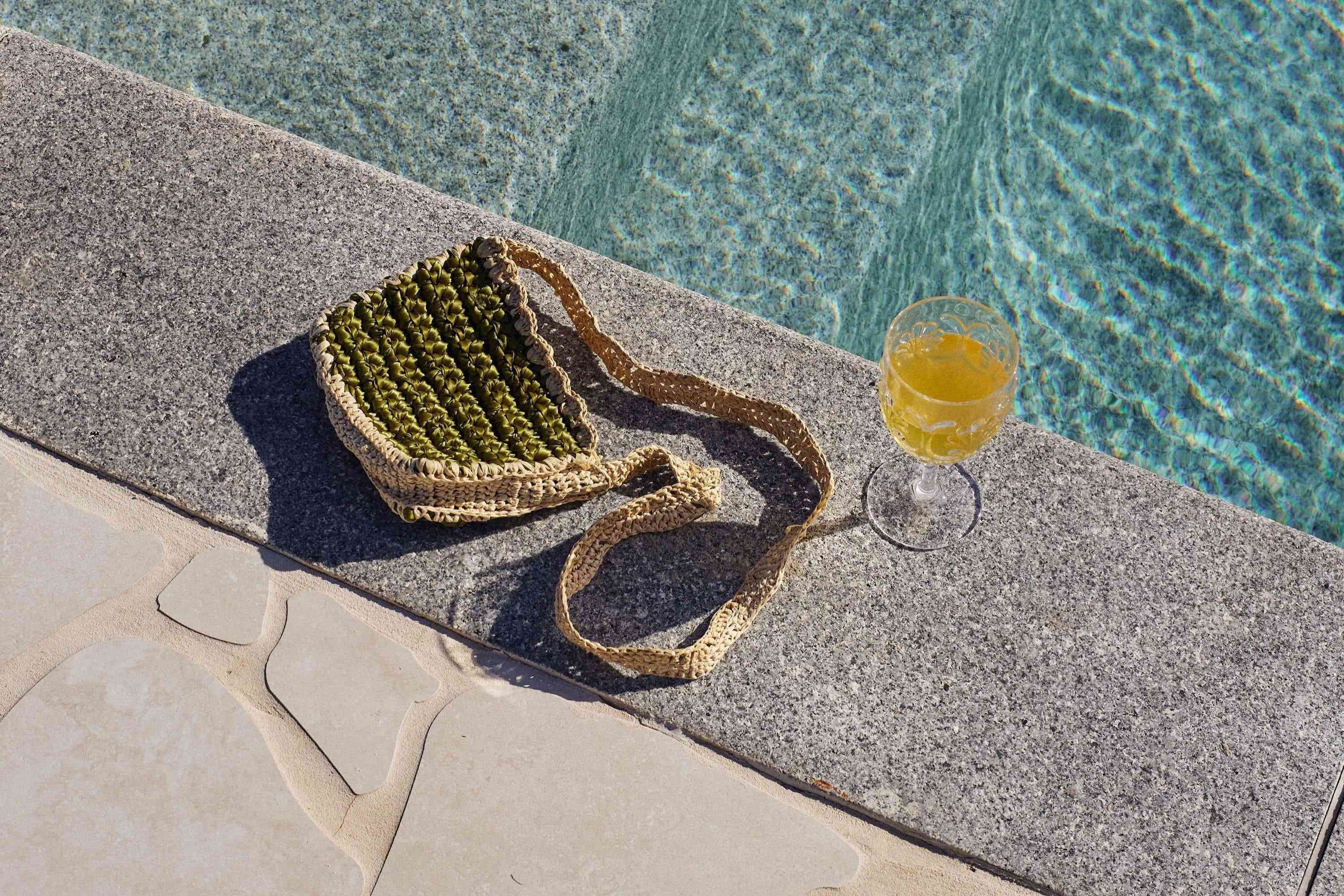 Poolside seating with a beach bag and refreshing drink at The Mook Mollymook.