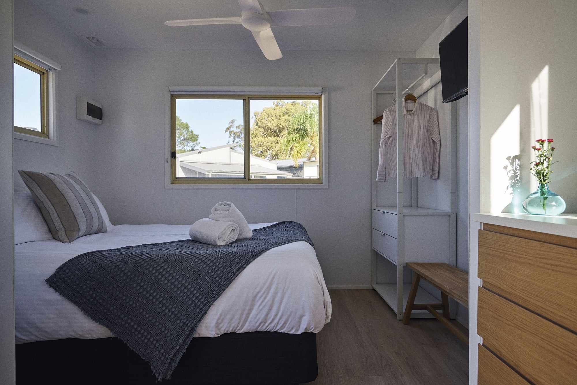 Main bedroom with queen bed and stand alone wardrobe in Clyde B Cabin.