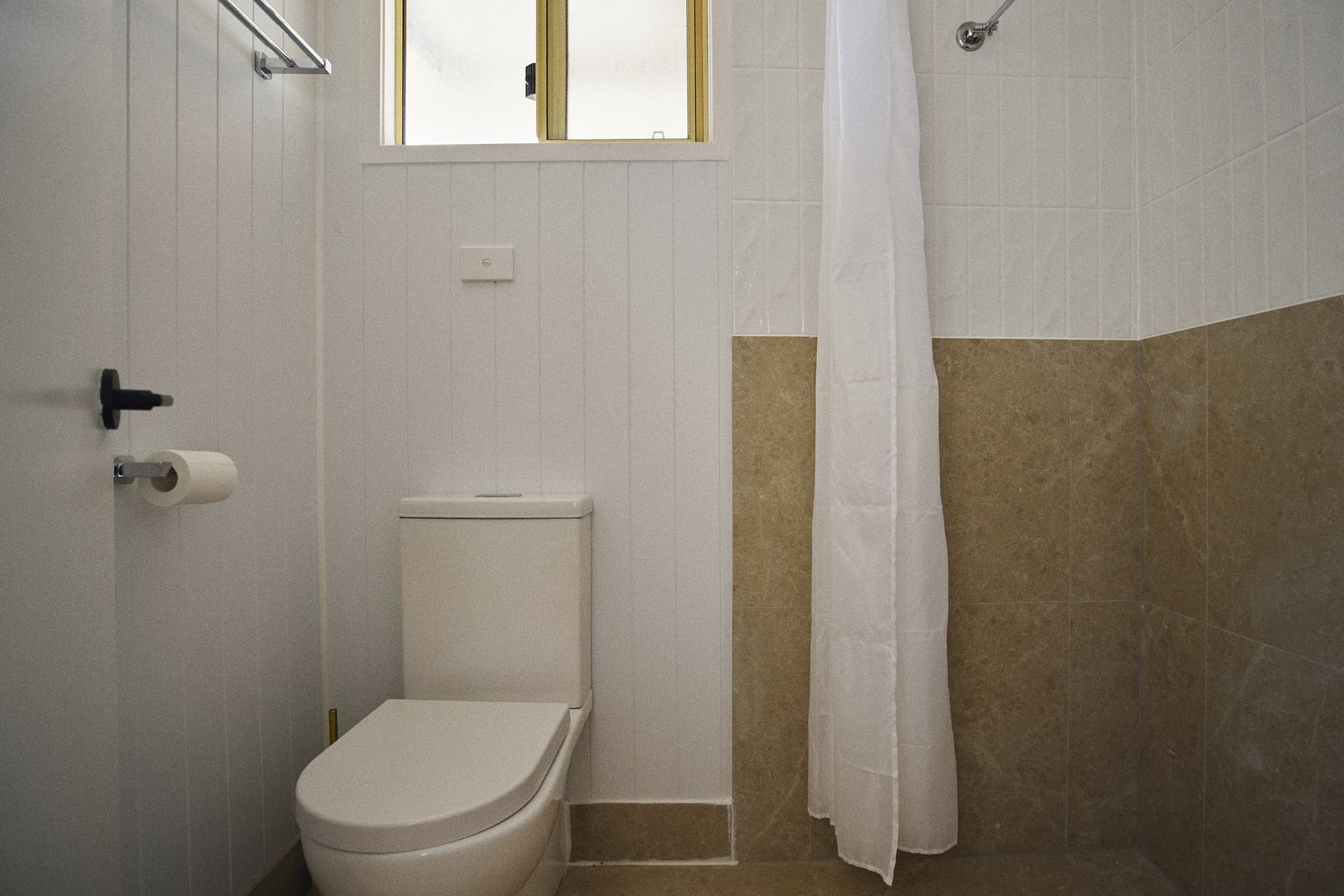 Bathroom toilet and shower in Clyde C Cabin.