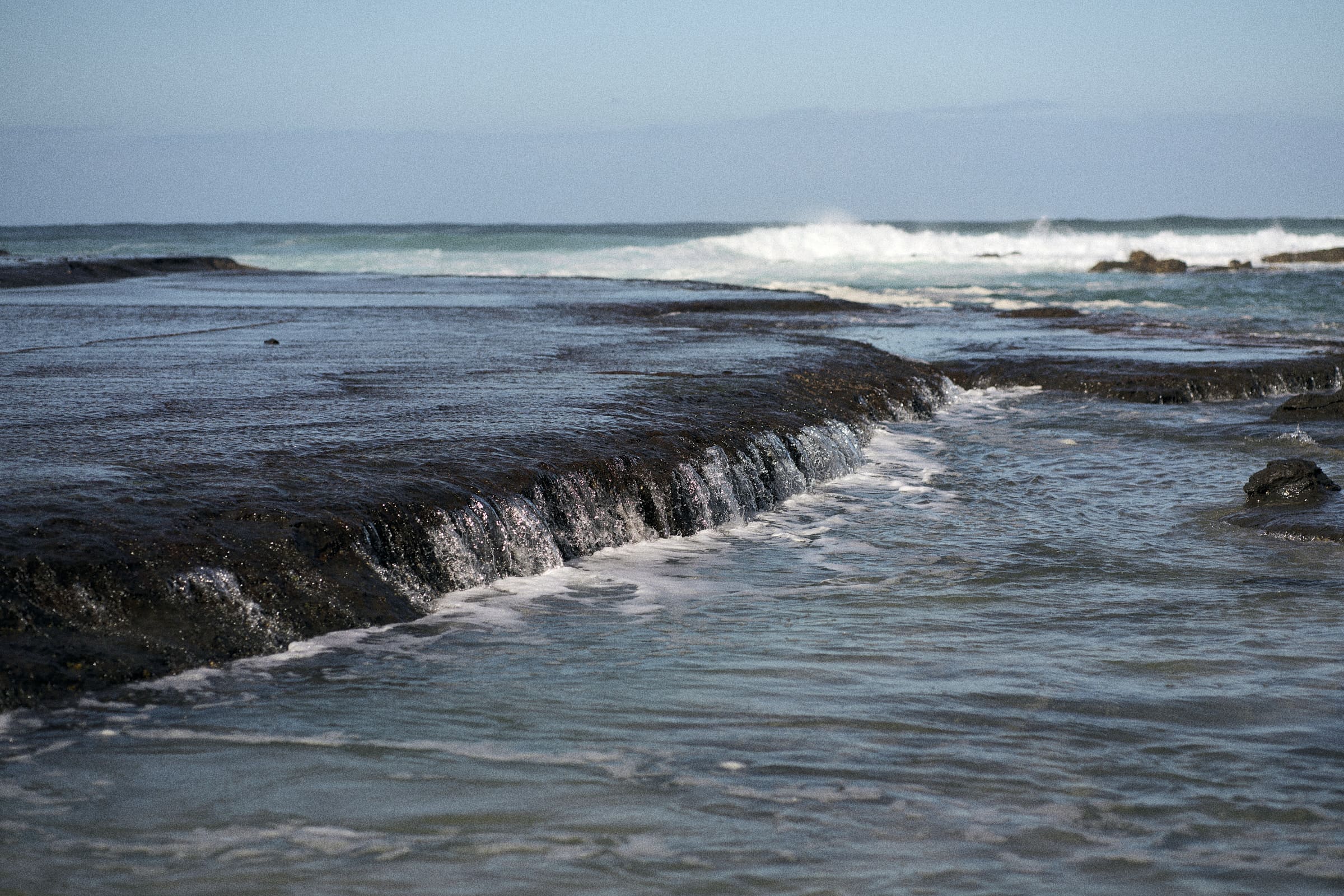 Waves breaking over a rock platform near Mollymook Beach.