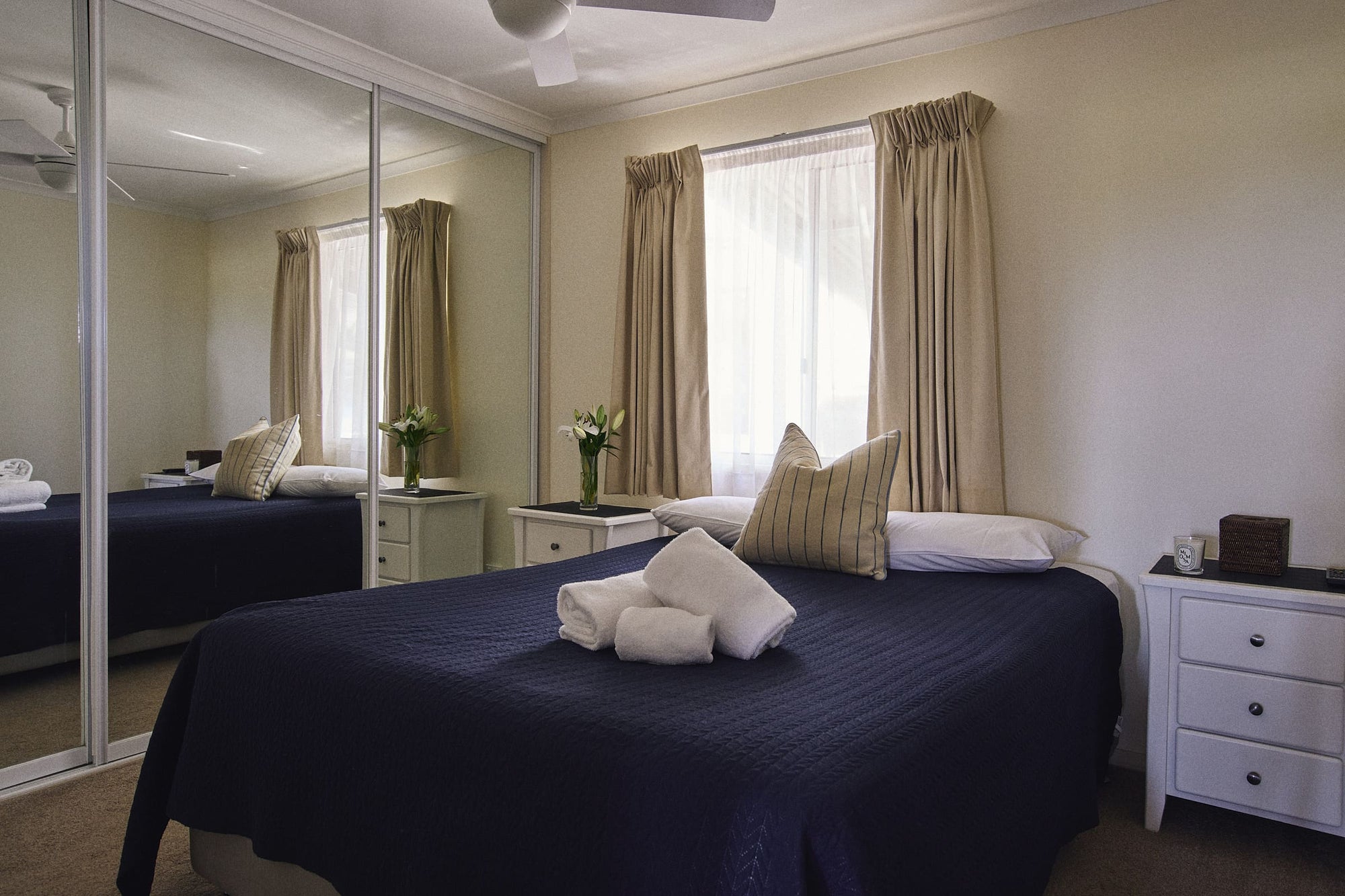 Main bedroom with queen bed and wardrobe in Meroo House.