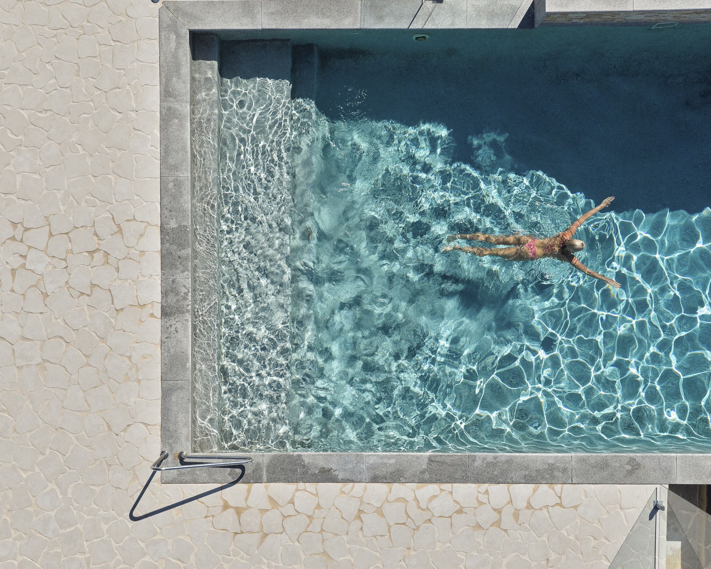 Guest swimming in the renovated pool at The Mook Mollymook.