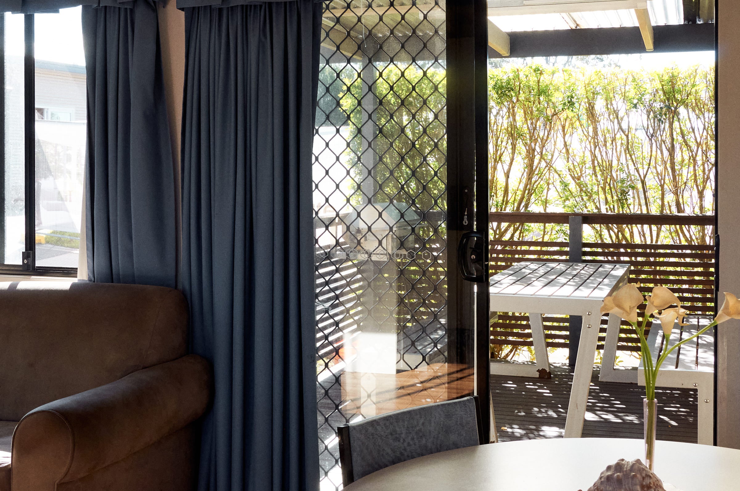 Covered deck with outdoor seating at Jerrawangala Cabin.