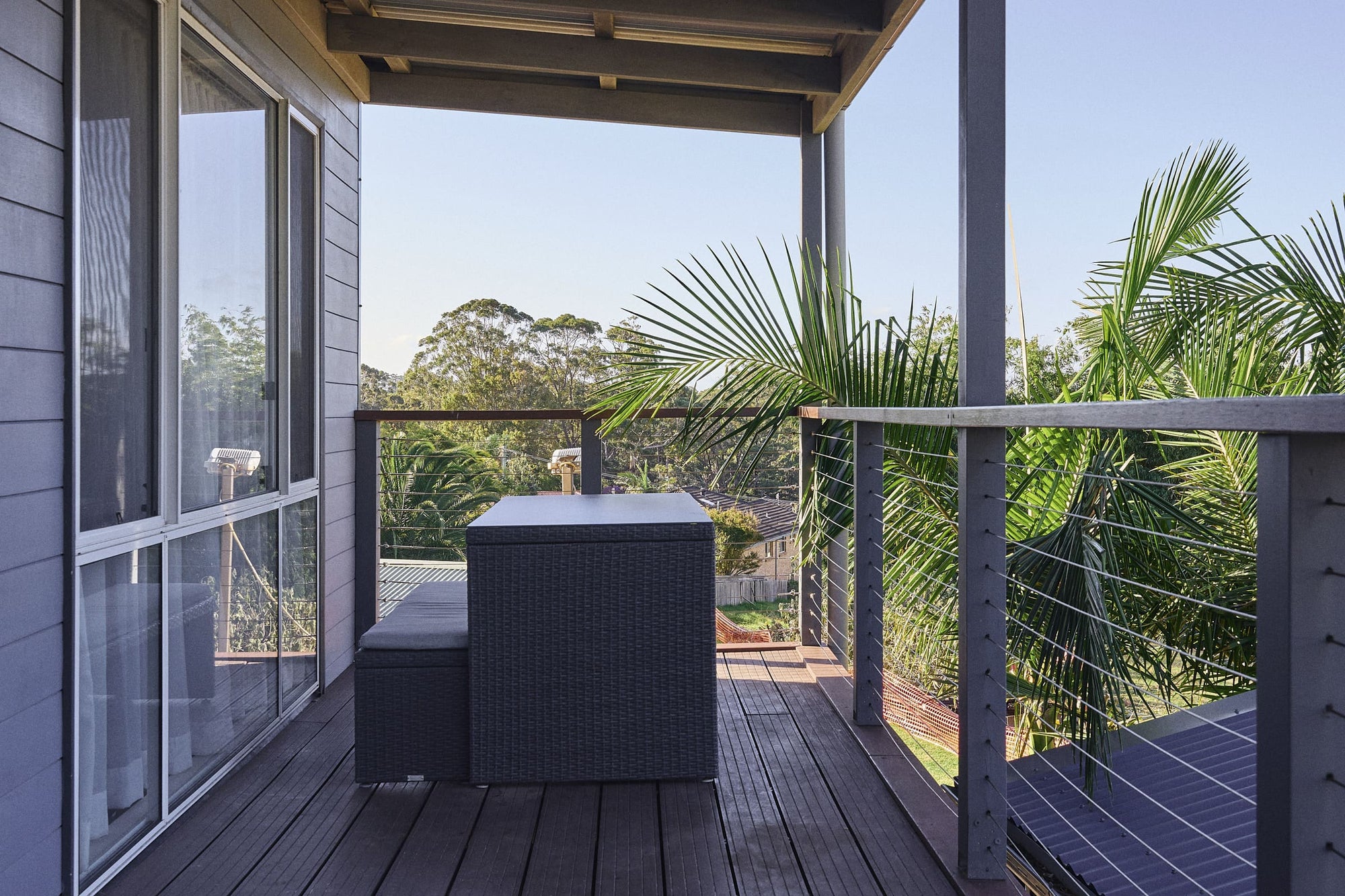 Covered balcony with outdoor seating in Meroo House.