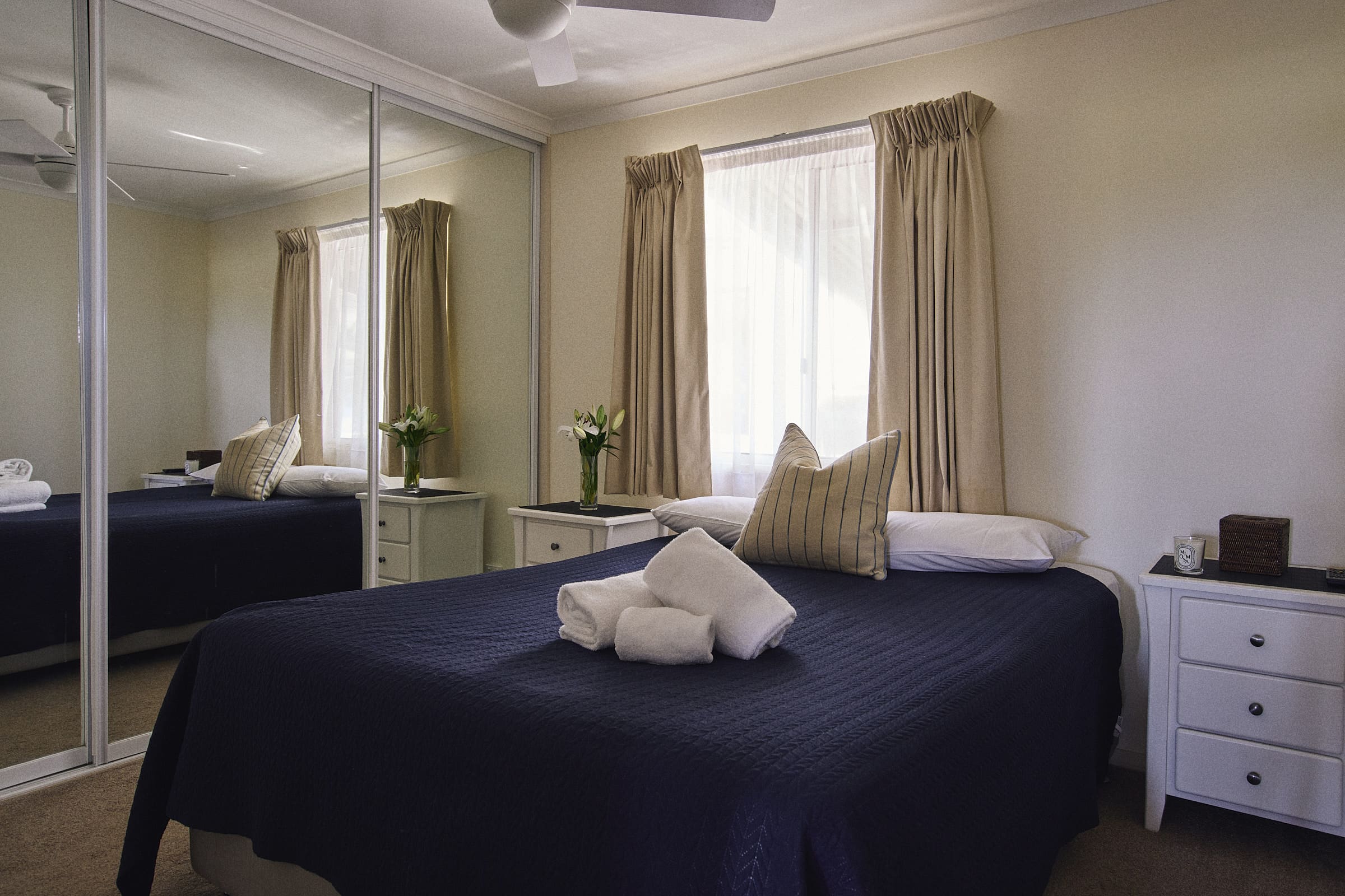 Main bedroom with queen bed and wardrobe in Meroo House.