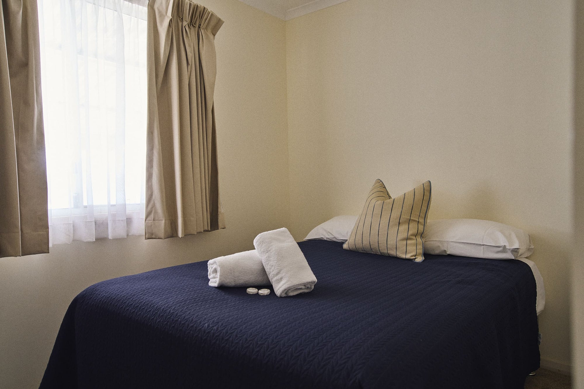 Main bedroom with queen bed in Meroo House.