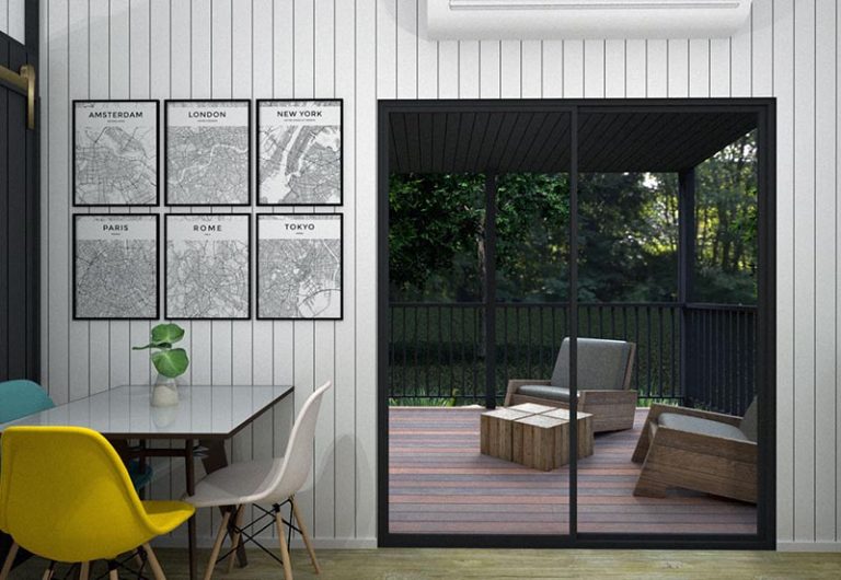 Dining area overlooking the covered deck with outdoor seating at Pebbly Tiny Homes Cabin.