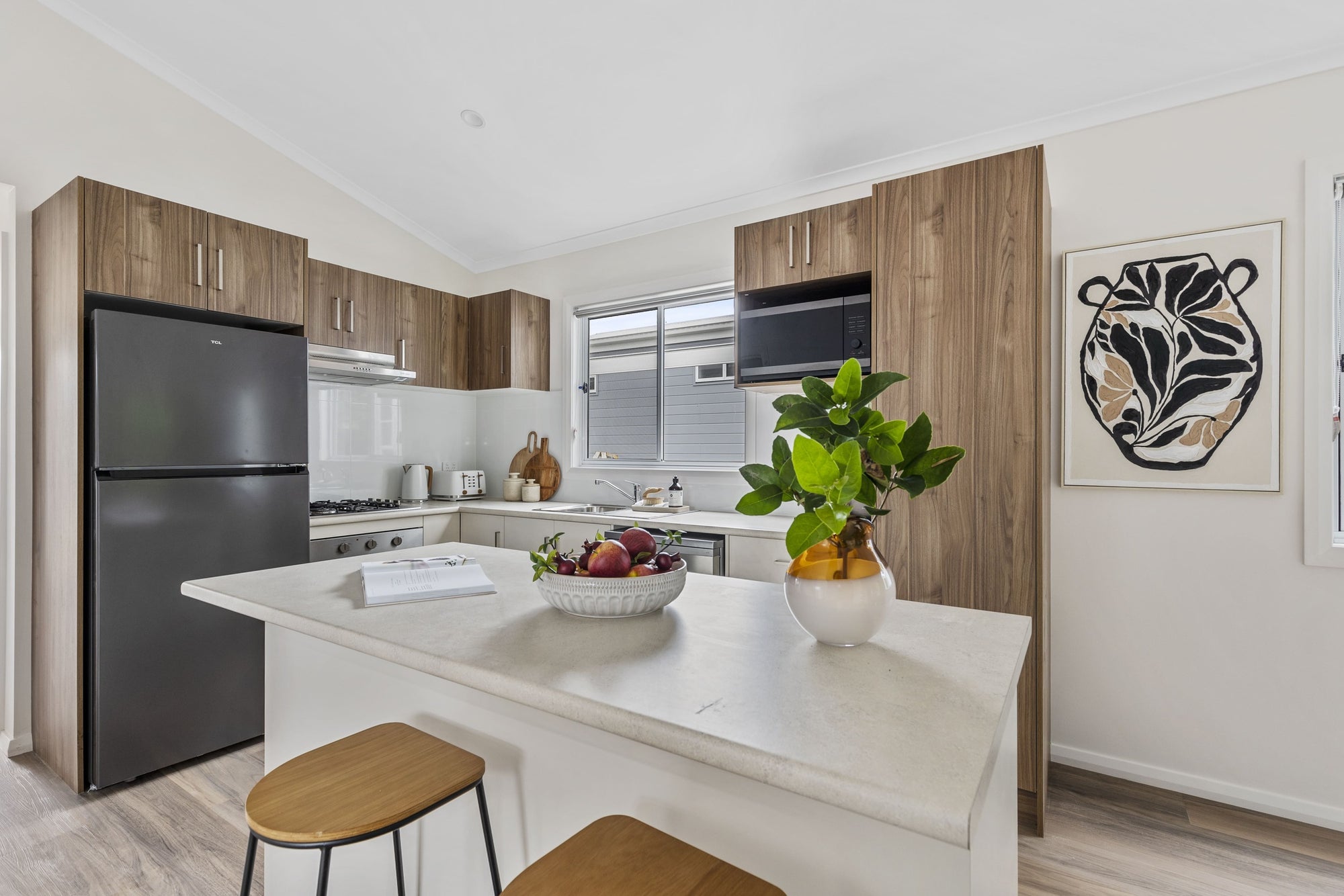 Kitchen and island with seating at 32 Ilett Street residence.