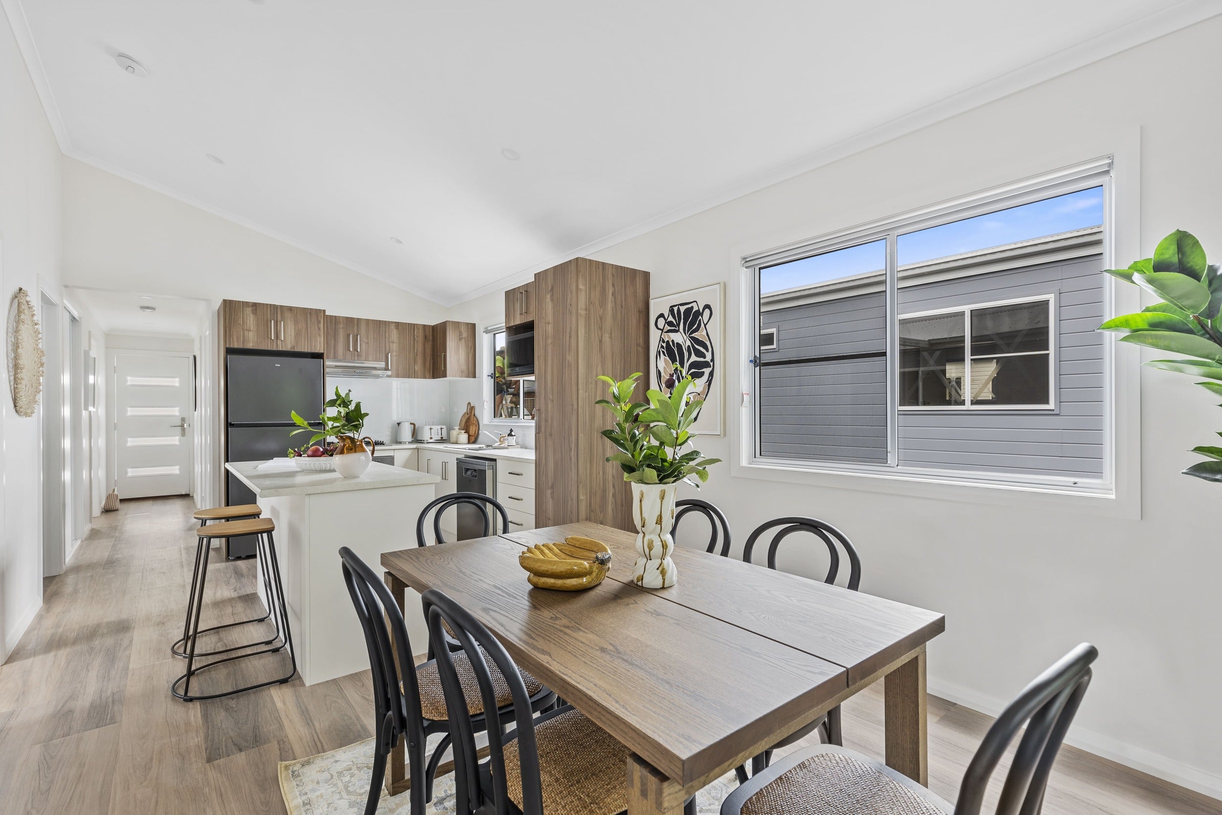 Open-plan living area looking towards the entry of 32 Ilett Street residence.