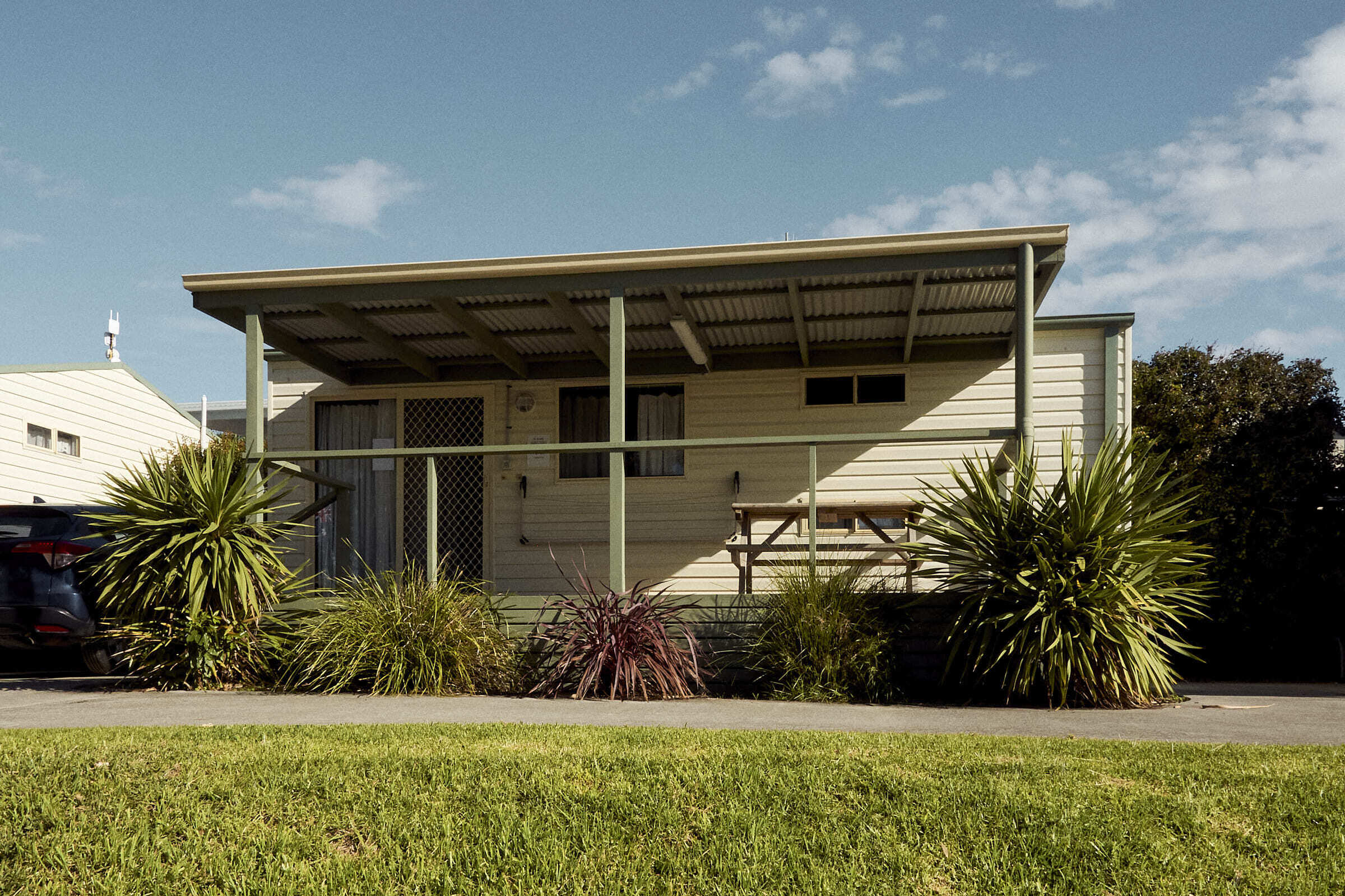 Yerriyong A Cabin exterior with covered outdoor seating.