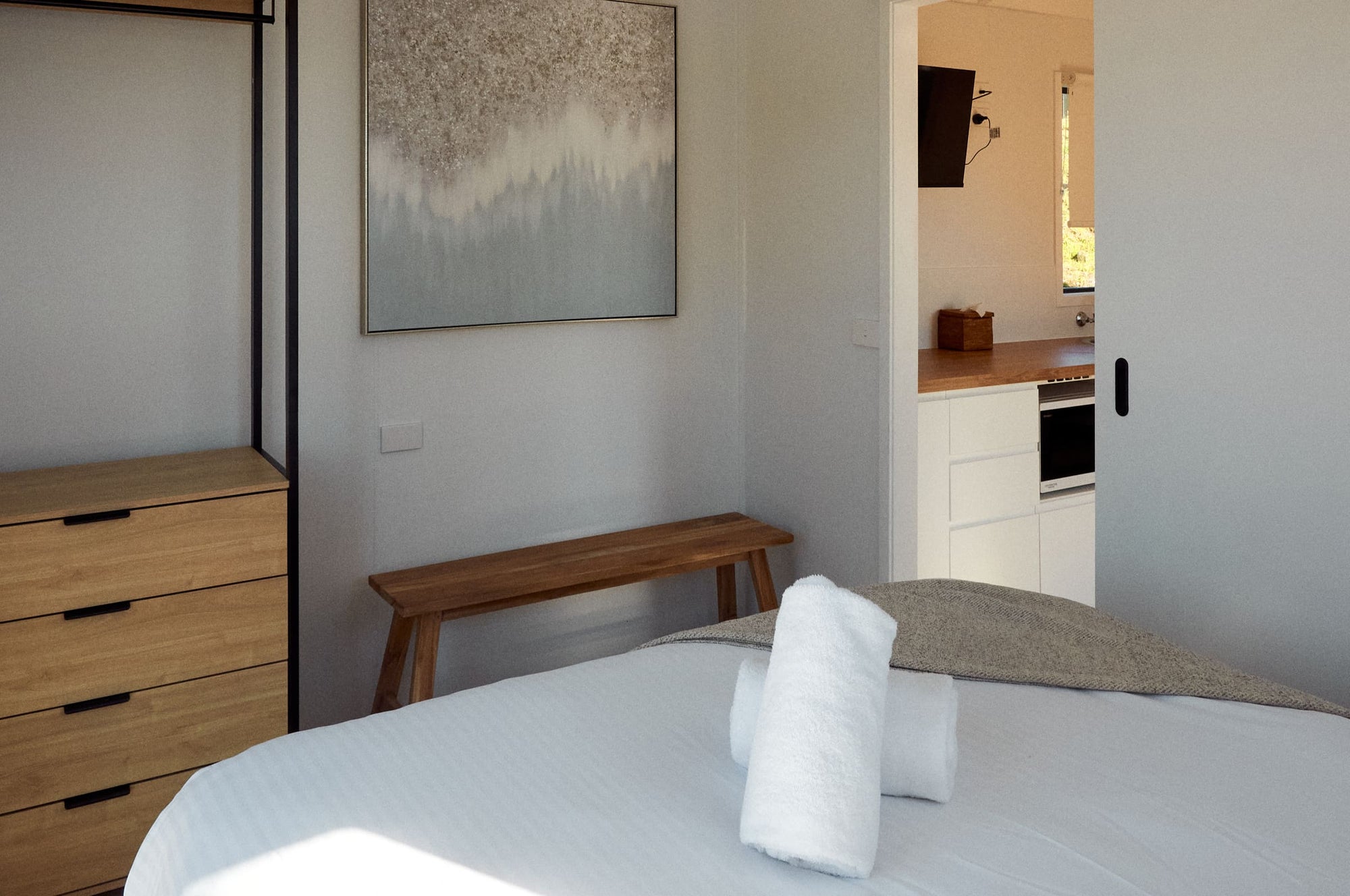 Main bedroom with queen bed and stand alone wardrobe in Yerriyong B Cabin.